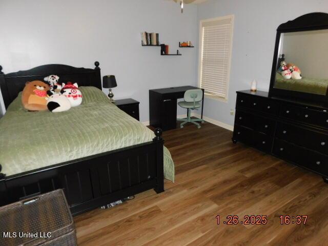 bedroom featuring dark wood-type flooring