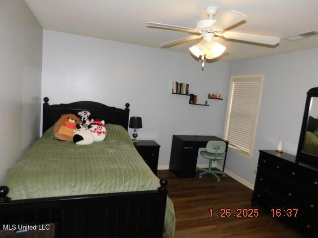 bedroom featuring ceiling fan and dark hardwood / wood-style flooring