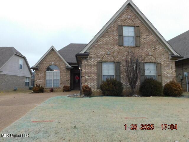 front facade with a front lawn