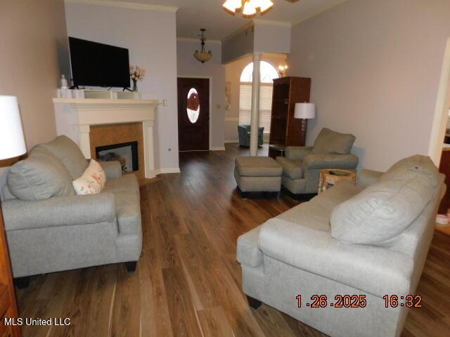 living room featuring crown molding and hardwood / wood-style floors