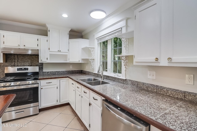 kitchen featuring stainless steel appliances, crown molding, sink, light tile patterned floors, and white cabinetry