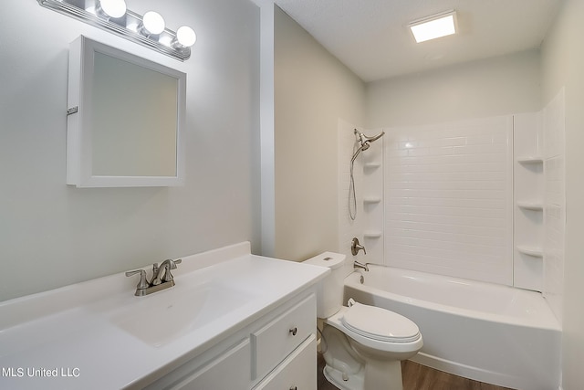 full bathroom with toilet, tiled shower / bath, hardwood / wood-style floors, and vanity