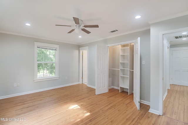 unfurnished bedroom featuring a closet, ornamental molding, light wood-type flooring, and ceiling fan