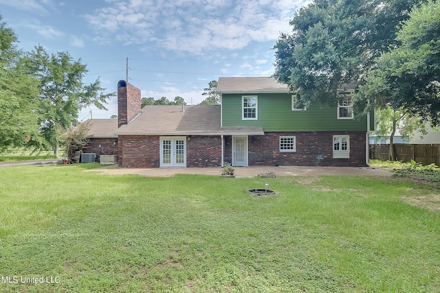 rear view of house featuring a patio, french doors, a yard, and central AC unit