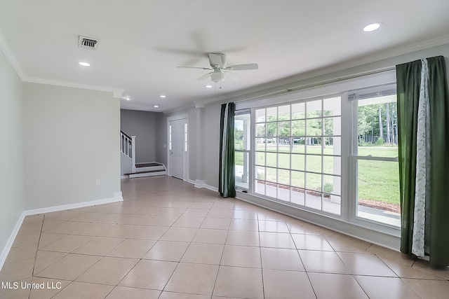 tiled empty room featuring crown molding and ceiling fan