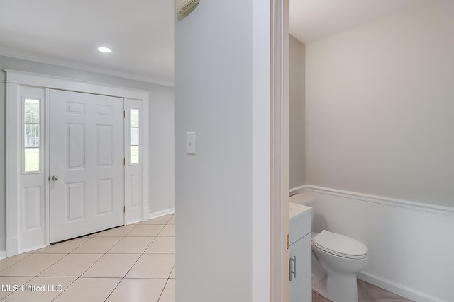 tiled foyer entrance with ornamental molding