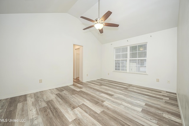 spare room featuring vaulted ceiling, ceiling fan, and light hardwood / wood-style flooring