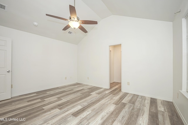 spare room featuring lofted ceiling, light hardwood / wood-style floors, and ceiling fan