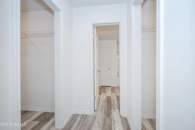 corridor with light hardwood / wood-style flooring