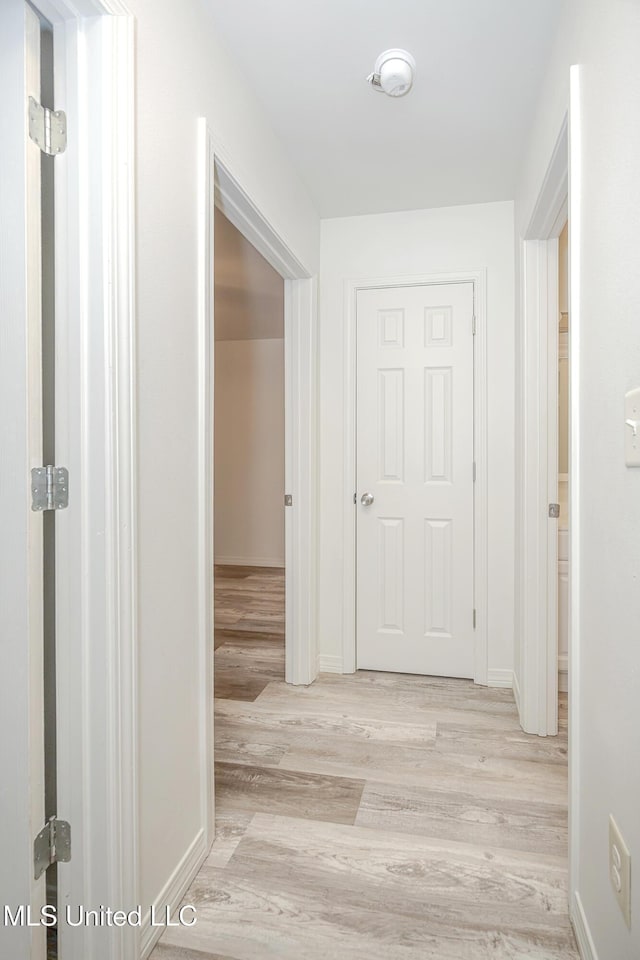 hall with light wood-type flooring