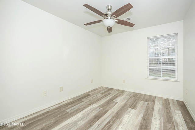 unfurnished room with ceiling fan and light wood-type flooring