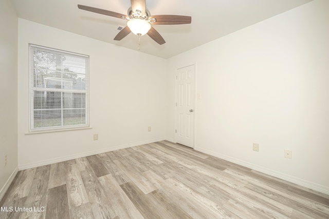 spare room with ceiling fan and light wood-type flooring