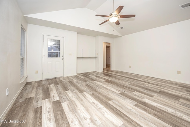 unfurnished living room featuring vaulted ceiling, light hardwood / wood-style floors, and ceiling fan