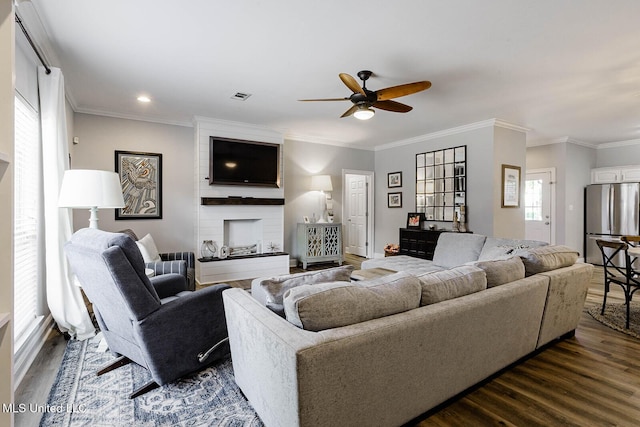 118 Armand Oaks, Ocean Springs, MS 39564 - living area featuring a ceiling fan, dark wood-type flooring, crown molding, and a fireplace