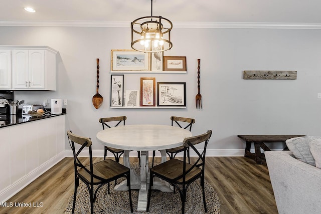 118 Armand Oaks, Ocean Springs, MS 39564 - dining area with dark wood-style floors, baseboards, ornamental molding, a chandelier, and recessed lighting