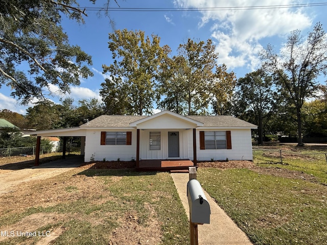 ranch-style home with a carport, a porch, and a front lawn