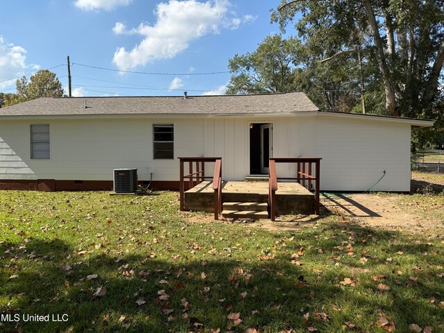 back of property featuring a yard, a deck, and central air condition unit