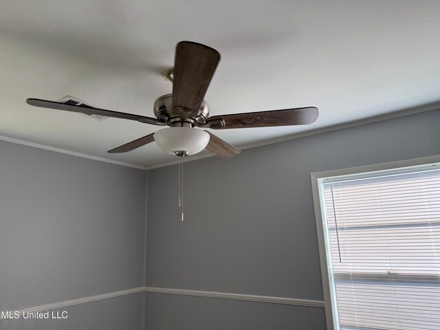 room details featuring ornamental molding and ceiling fan