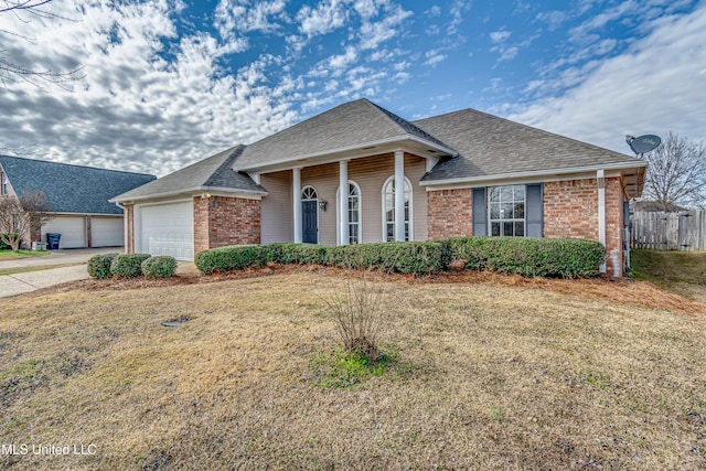 ranch-style home with a front lawn and a garage