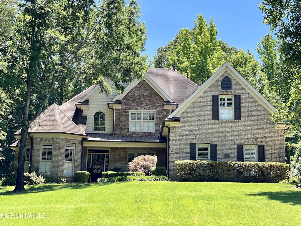 5701 Burlington Ln, Olive Branch, MS 38654 - craftsman-style house featuring roof with shingles, a front lawn, a standing seam roof, and brick siding