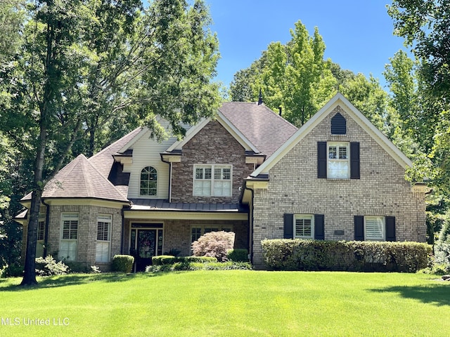 5701 Burlington Ln, Olive Branch, MS 38654 - craftsman-style house featuring roof with shingles, a front lawn, a standing seam roof, and brick siding