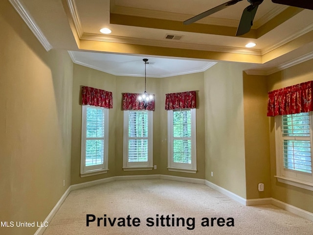 unfurnished dining area with a tray ceiling, ornamental molding, carpet flooring, and a healthy amount of sunlight