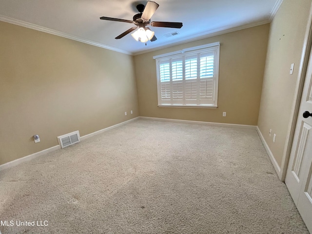 carpeted empty room featuring crown molding and ceiling fan