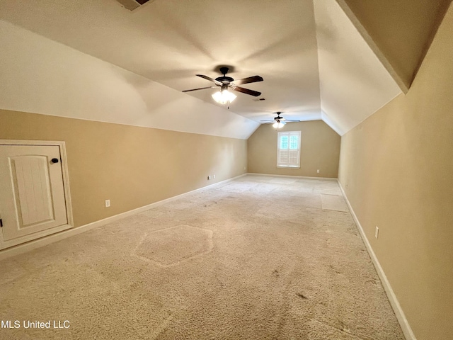 bonus room with ceiling fan, vaulted ceiling, and light colored carpet