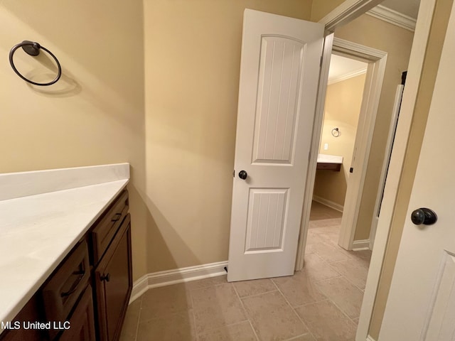 bathroom with vanity, crown molding, and tile patterned floors