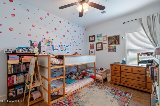 bedroom with wood finished floors and a ceiling fan