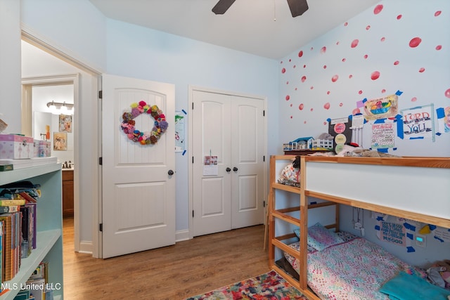bedroom with wood finished floors, a closet, and a ceiling fan