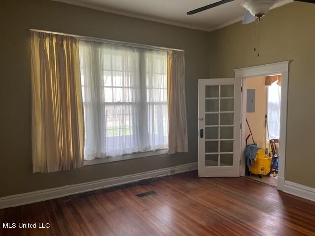 unfurnished room featuring dark wood-type flooring, ceiling fan, ornamental molding, and electric panel