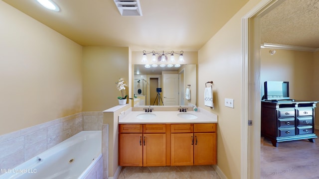 bathroom with vanity, a textured ceiling, and a bath