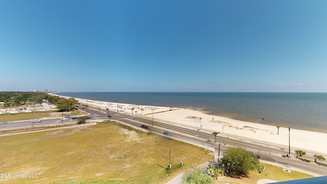 birds eye view of property with a water view and a beach view