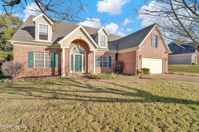 view of front of home with a front lawn and a garage