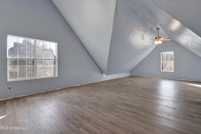 additional living space featuring hardwood / wood-style flooring, vaulted ceiling, and ceiling fan