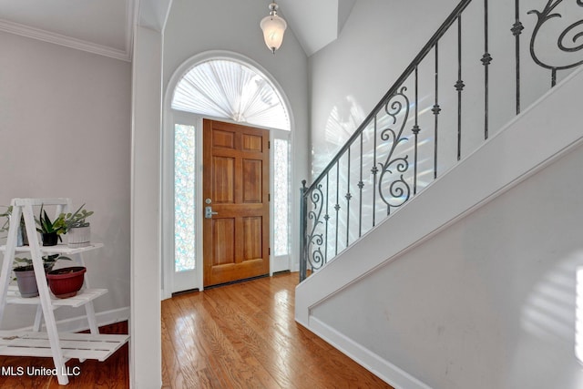 entrance foyer with light wood-type flooring and ornamental molding