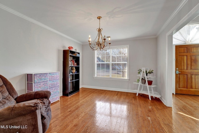 sitting room featuring a chandelier, ornamental molding, and light hardwood / wood-style flooring