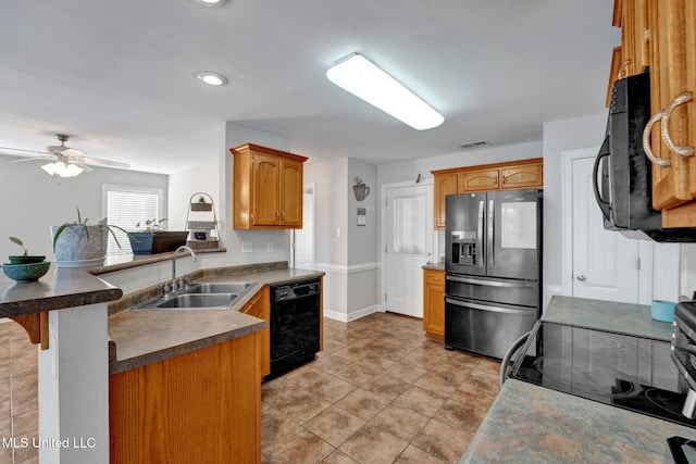 kitchen featuring a kitchen bar, kitchen peninsula, ceiling fan, sink, and black appliances