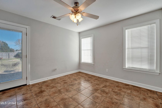 empty room with tile patterned flooring and ceiling fan