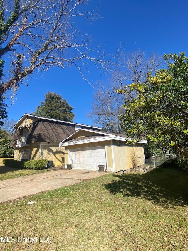 view of side of home with a yard and a garage