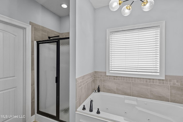 bathroom with a tub with jets and a shower stall