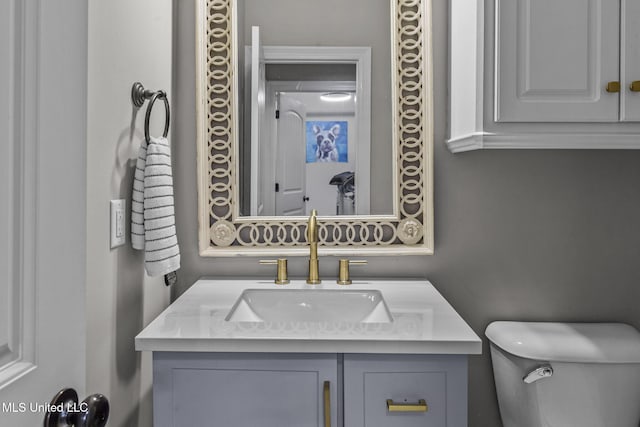 bathroom featuring toilet and vanity