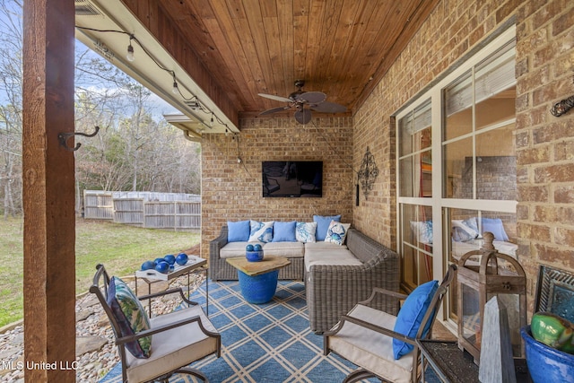 view of patio / terrace featuring ceiling fan, fence, and an outdoor living space