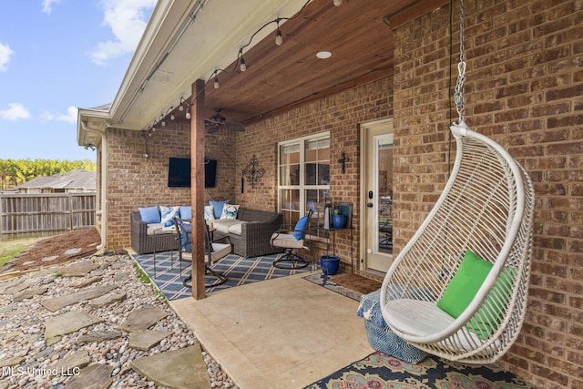 view of patio / terrace with fence, an outdoor living space, and ceiling fan