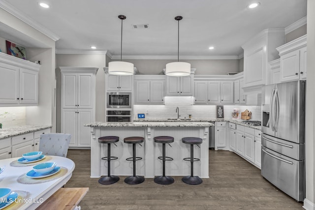 kitchen featuring appliances with stainless steel finishes, white cabinetry, a sink, and dark wood-style floors