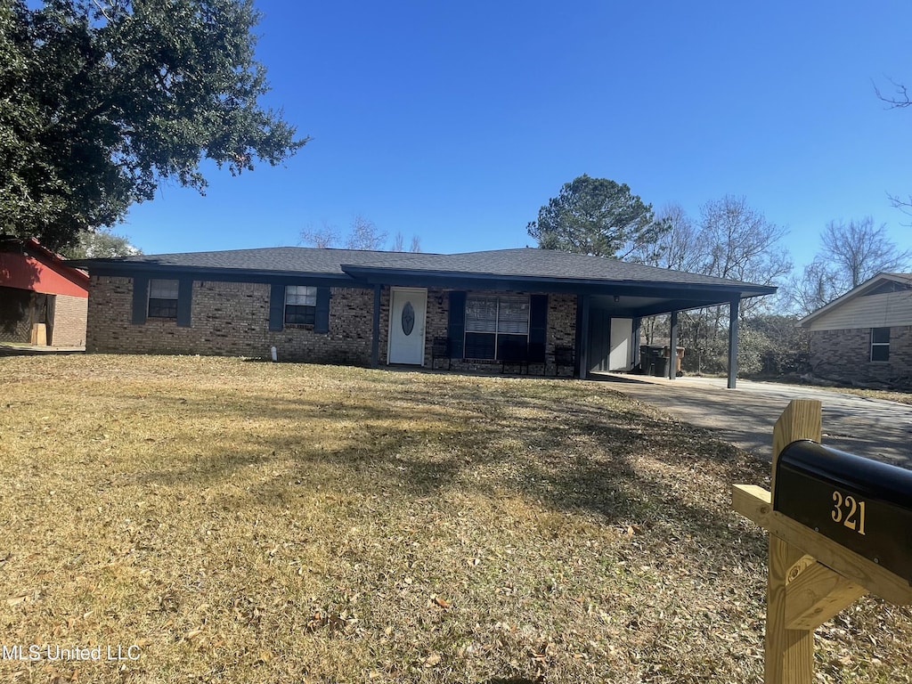 ranch-style house featuring a carport and a front lawn