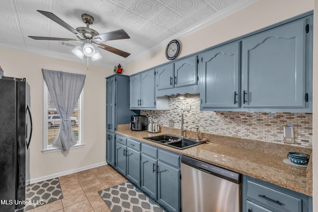 kitchen featuring dishwasher, black fridge, sink, light tile patterned floors, and blue cabinets