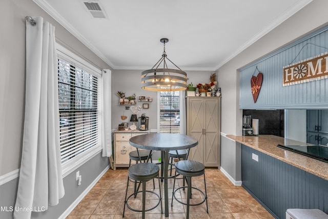 dining area featuring a healthy amount of sunlight, light tile patterned flooring, a chandelier, and ornamental molding