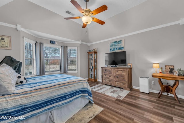 bedroom with ceiling fan, dark wood-type flooring, crown molding, and lofted ceiling